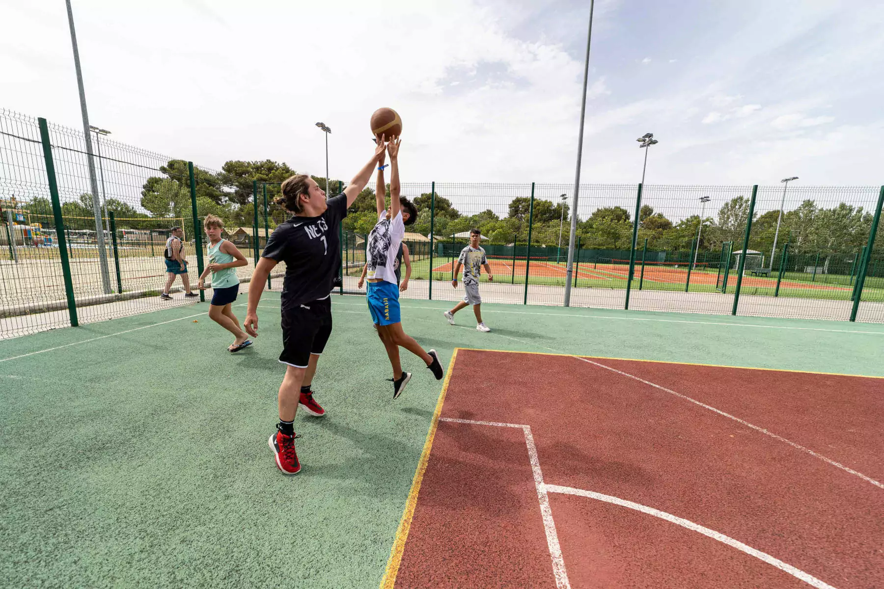 ragazzini che giocano a basket nel campo del centro vacanze