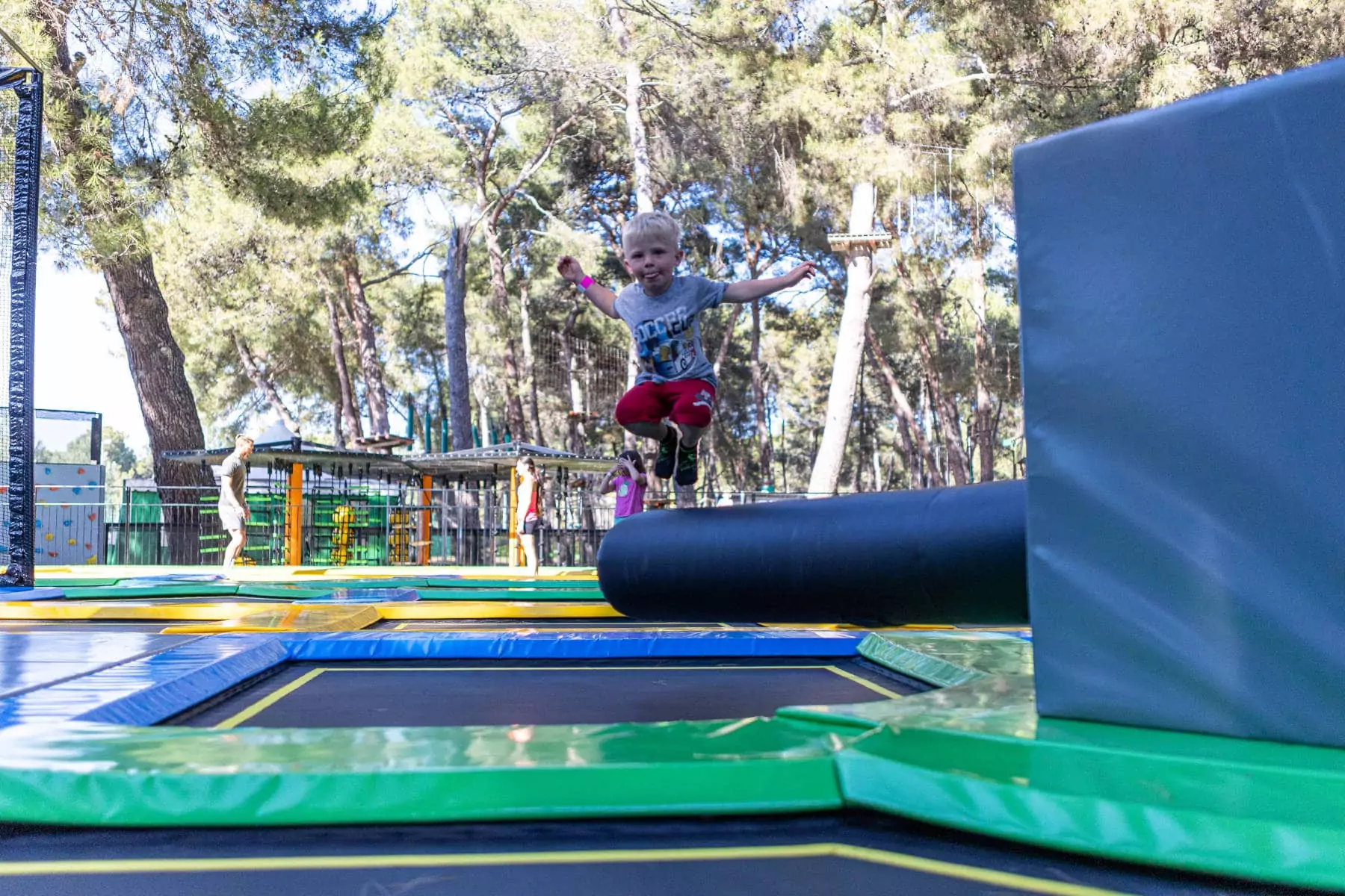 bambino che salta sul trampolino nel parco giochi jangalooz